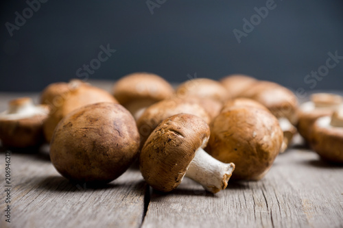 Fresh mushrooms on the rustic wooden background. Selective focus. Shallow depth of field.