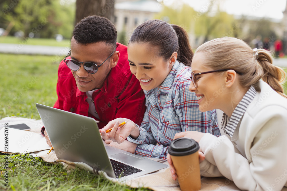 Chatting students. Three hard-working students chatting via skype with their professor while asking for advice Chatting students. Three hard-working students chatting via skype with their professor while asking for advice