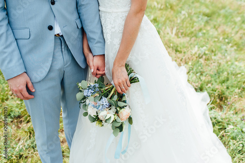 bride in a dress holding a wedding bouquet