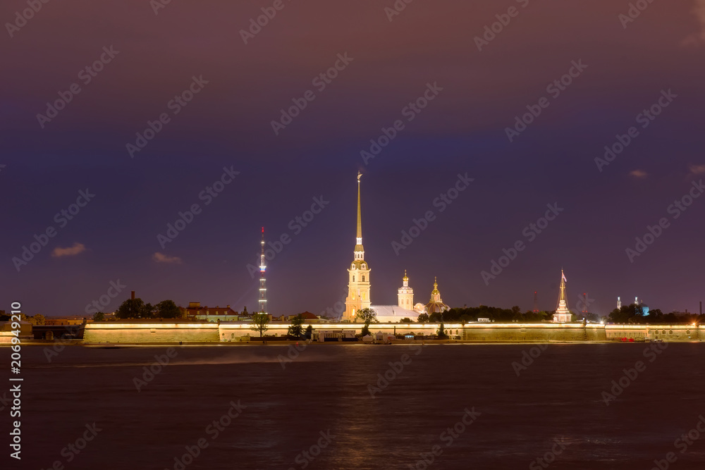 RUSSIA, SAINT PETERSBURG - AUGUST 18, 2017: View on the Peter and Paul Fortress, the river Neva, the steeple with a cross on a dark summer night