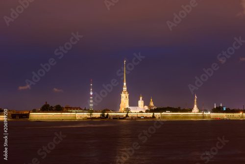 RUSSIA, SAINT PETERSBURG - AUGUST 18, 2017: View on the Peter and Paul Fortress, the river Neva, the steeple with a cross on a dark summer night