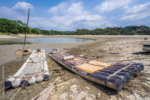 Lake of Dreams, a small but beautiful fishing port located in Wushantou Reservoir, Guantian, Tainan, Taiwan is drying up with cracks and bamboo boats are left aside. photo