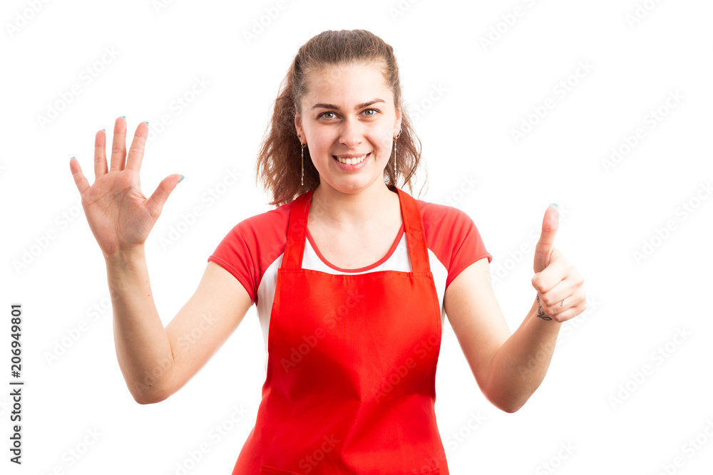 Woman supermarket employee or storekeeper showing number six. Woman supermarket employee or storekeeper showing number six.
