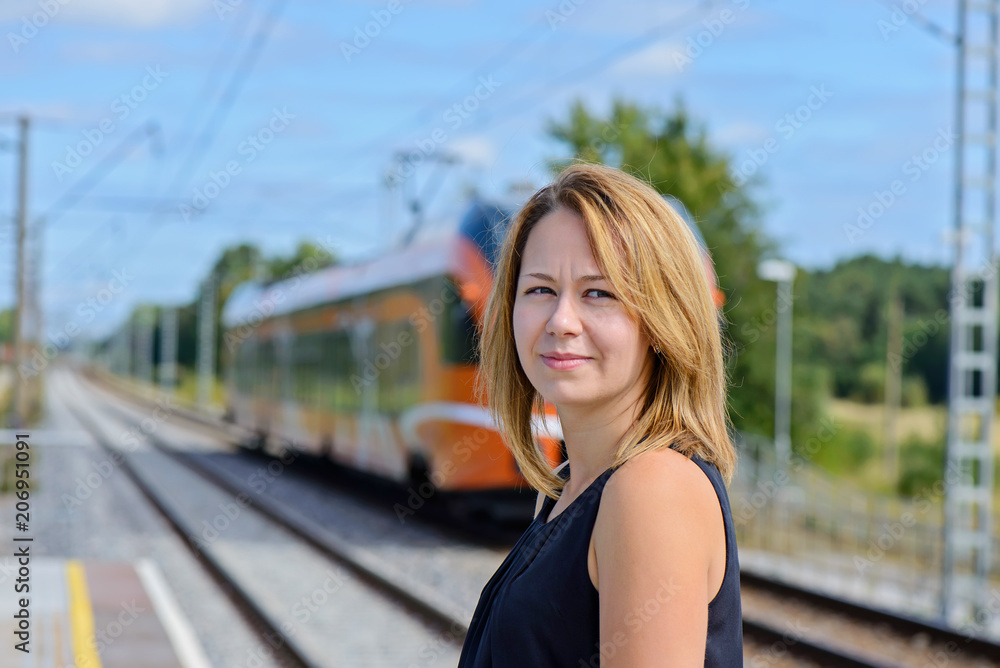Female waiting train on the platform