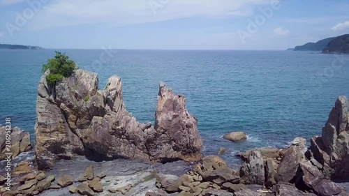 Aerial revealing pan, Hashiguiiwa standing rock formation at low tide in Wakayama prefecture Japan. photo