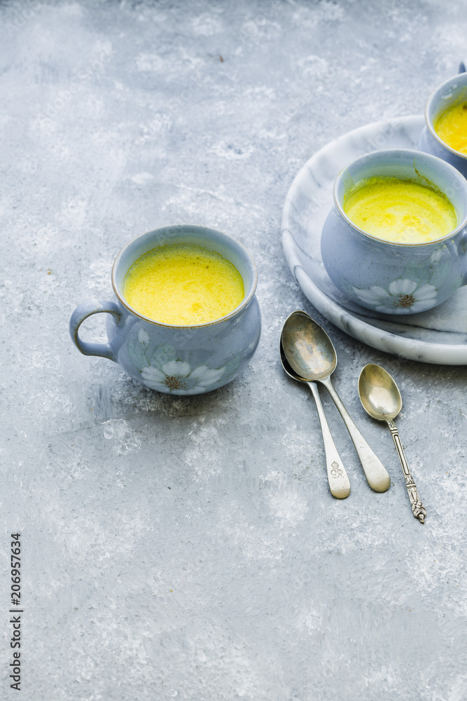 Golden Turmeric Milk served in Blue Mugs Golden Turmeric Milk served in Blue Mugs