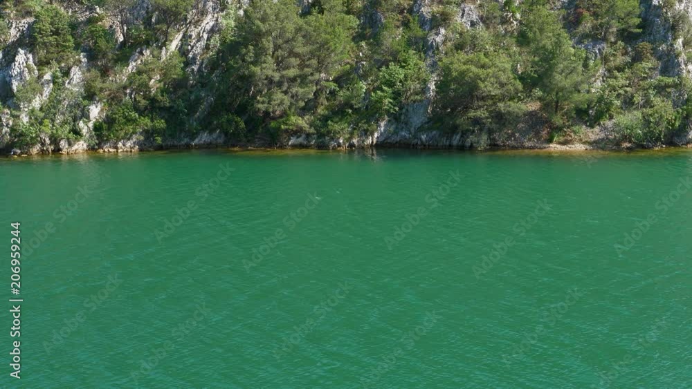 turquoise river with rock cliff border background turquoise river with rock cliff border background