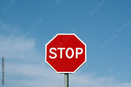 Stop sign against cloudy sky.