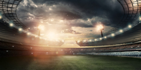 Stadium in the lights and flashes, football field. Concept sports background, football, night stadium. Mixed media, copy space.
