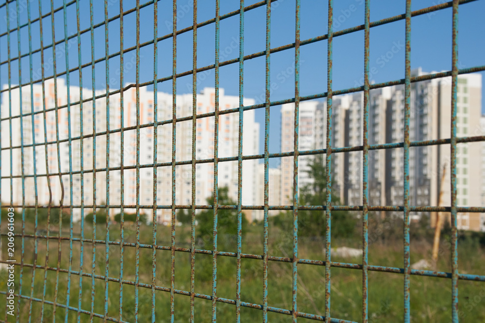 new houses behind bars, blur backgroound new houses behind bars, blur backgroound