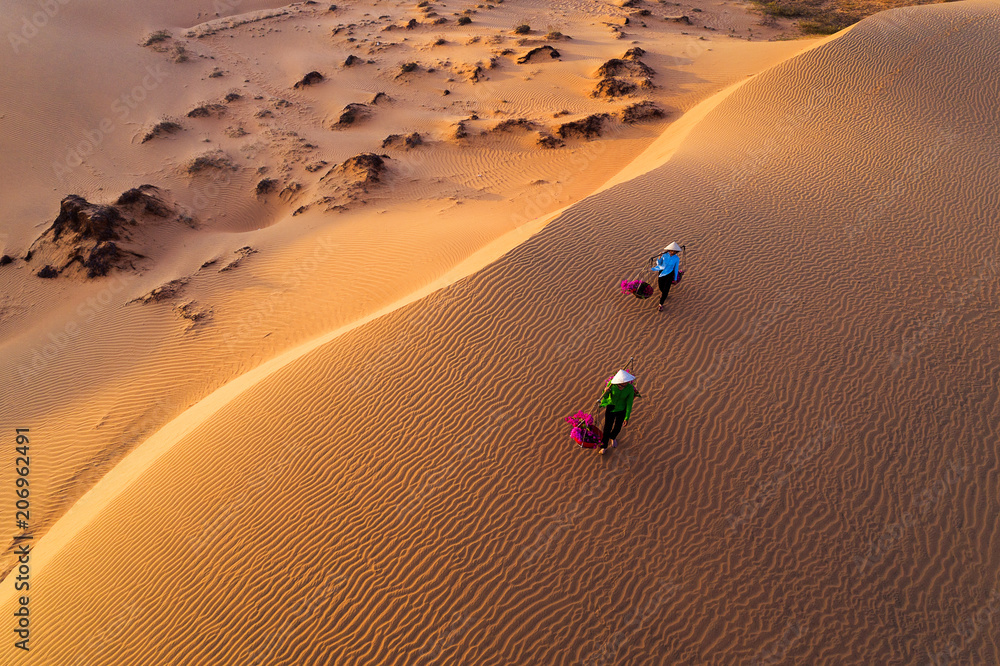 custom made wallpaper toronto digitalWoman carrying flower basket at sunset in Mui Ne sand dune, Vietnam