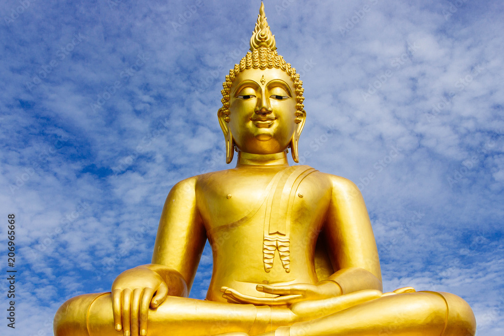 Great Golden Buddha statue in the sky in the daytime.