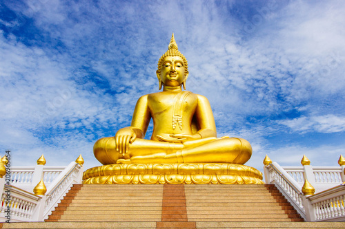 Great Golden Buddha statue in the sky in the daytime.