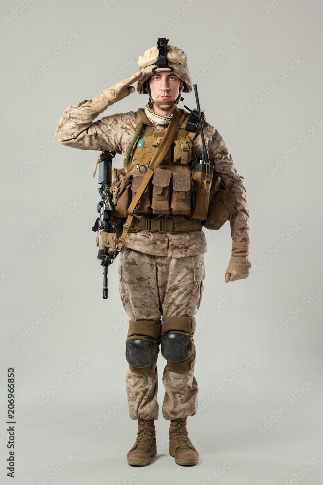 Fototapeta premium Soldier in camouflage holding rifle