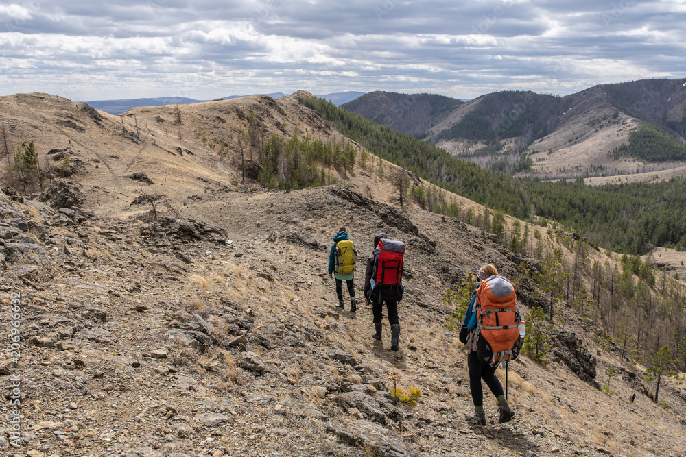 Group of three hikers on trail. Group of three hikers on trail.