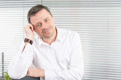 cheerful businessman handsome man in office with white shirt smiling