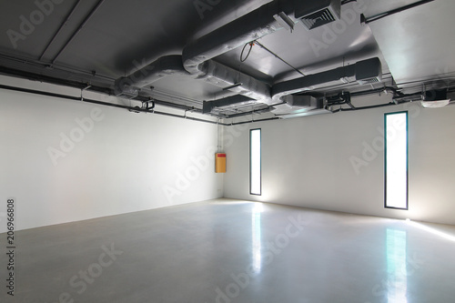 Empty office room on modern building with sunlight and indoor ventilation system on hight ceiling of large building