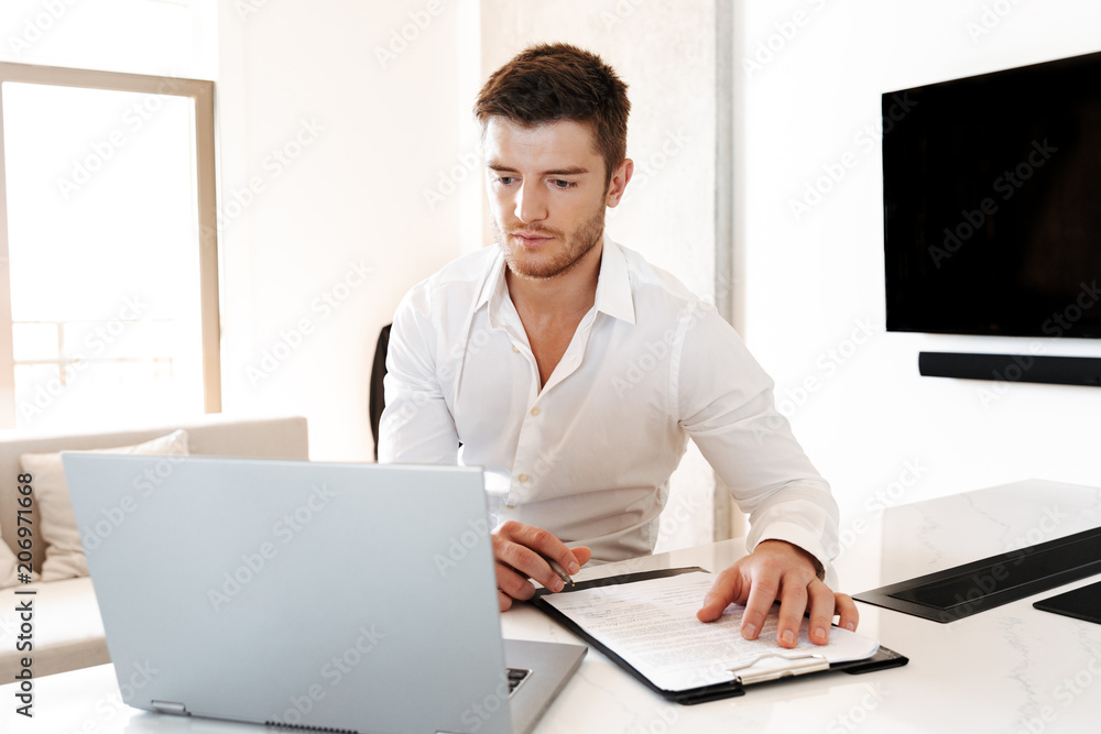 Handsome young man working with laptop computer Handsome young man working with laptop computer