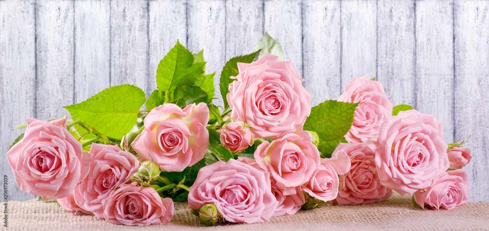 Rose flowers on background of shabby wooden planks Rose flowers on background of shabby wooden planks
