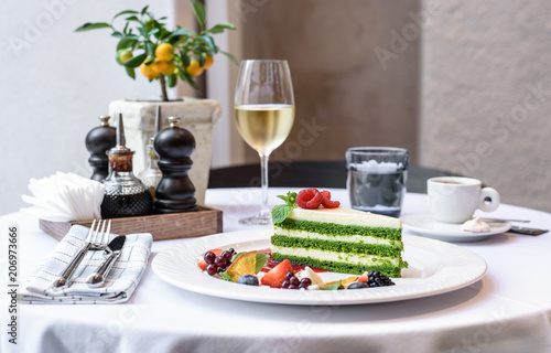 Large white dish, cheesecake with fresh berries. Bright bokeh background.