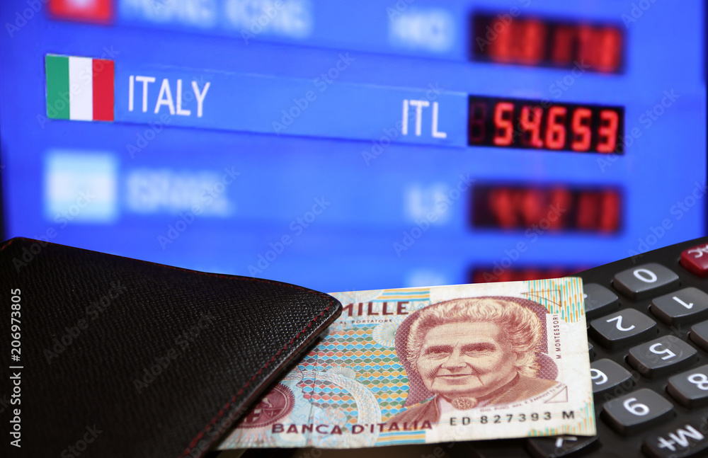 One thousand Lire of Italy banknote with black wallet on the calculator with digital board of currency exchange money background, Lire Italia money the concept of finance. One thousand Lire of Italy banknote with black wallet on the calculator with digital board of currency exchange money background, Lire Italia money the concept of finance.