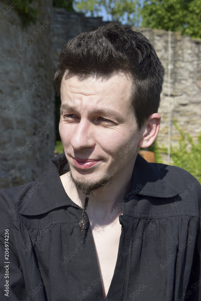 handsome young man in front of the castle wall handsome young man in front of the castle wall