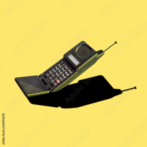 Vintage analog cellular phone with flip mouthpiece, dummy aerial and LED display; it was innovative and trendsetting, and its features were developed into modern mobile cellphone designs