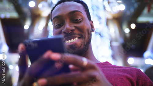 African American Man using business app on smart phone