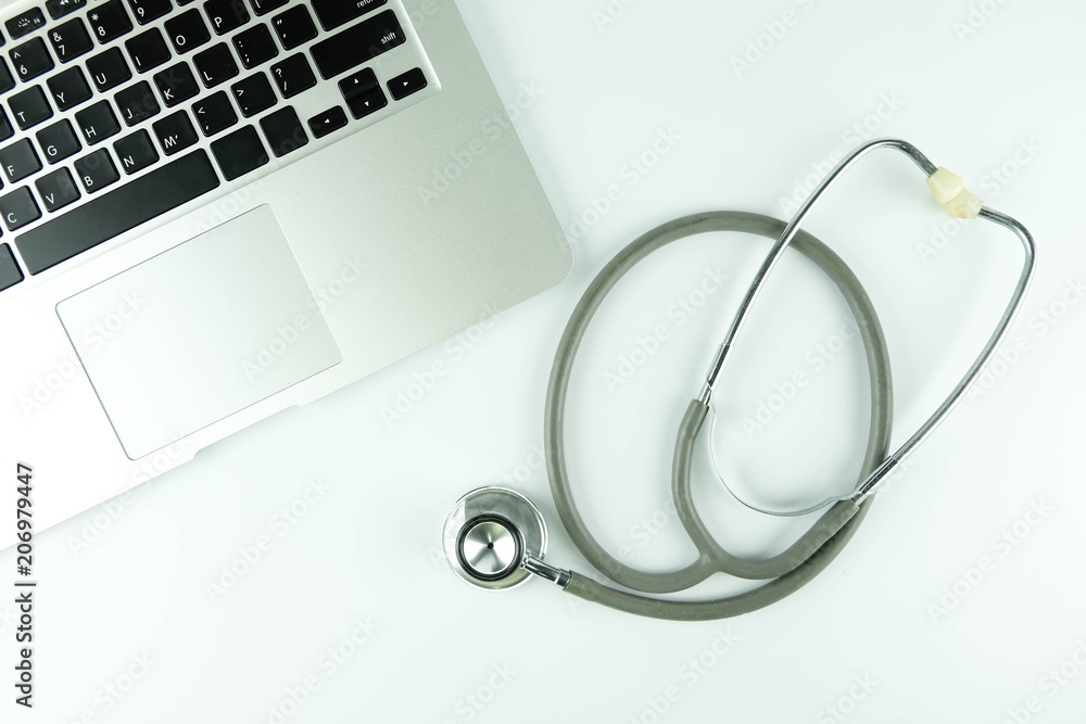 Doctor desk table with stethoscope and laptop on wooden table, medical workspace office.. Doctor desk table with stethoscope and laptop on wooden table, medical workspace office..