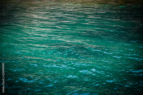 Turquoise sea surface with waves. Vignette.