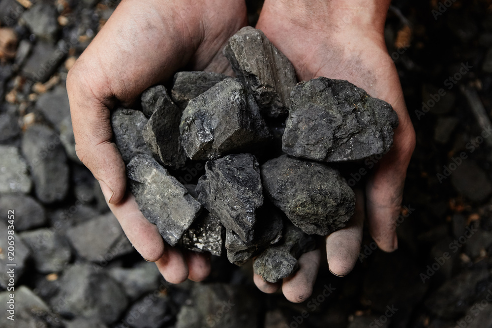 Coal miner in the man hands of coal background. Coal mining or energy ...