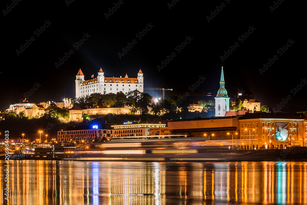 Bratislava, Slovakia May 23, 2018: Bratislava at night, with the city lights reflected in the Danube river. On the top hill stands the Bratislava Castle built in the 9th century.