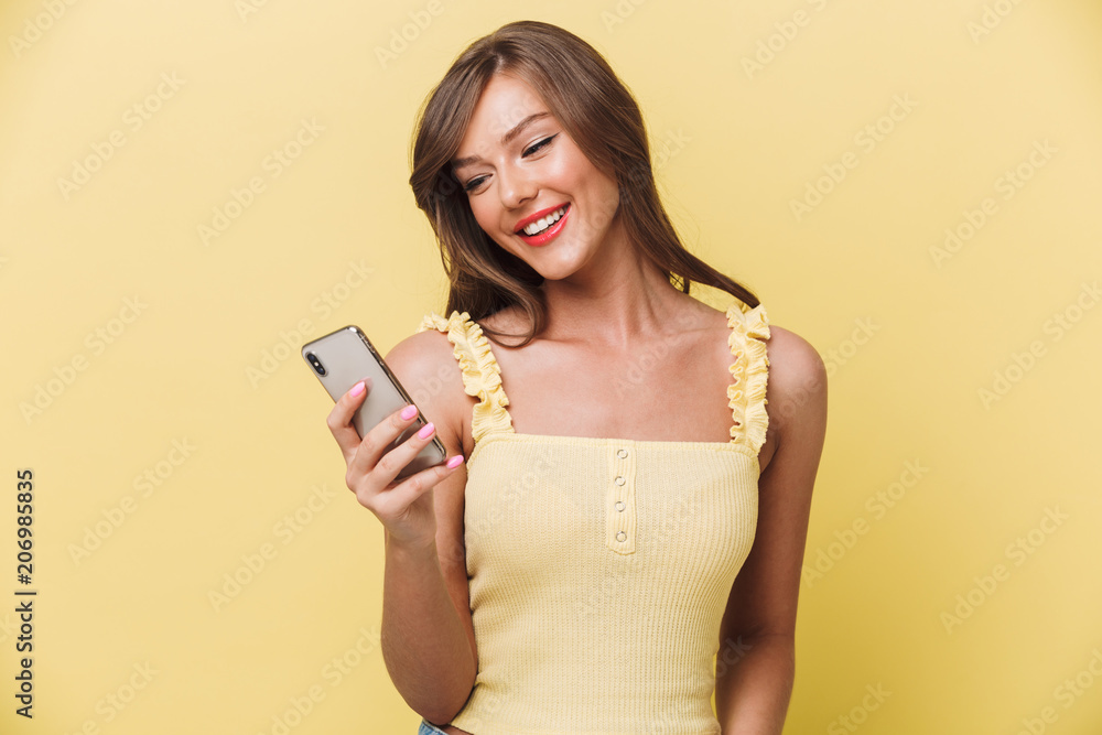 Portrait of a happy young girl looking at mobile phone Portrait of a happy young girl looking at mobile phone