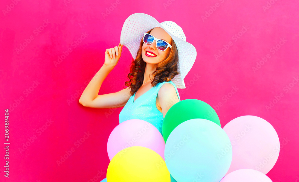 Happy elegant woman with an air colorful balloons is having fun on a pink background Happy elegant woman with an air colorful balloons is having fun on a pink background