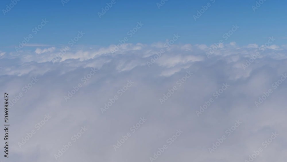 Aerial view from an airplane window of a thick clouds moving by fast and close to the viewer Aerial view from an airplane window of a thick clouds moving by fast and close to the viewer