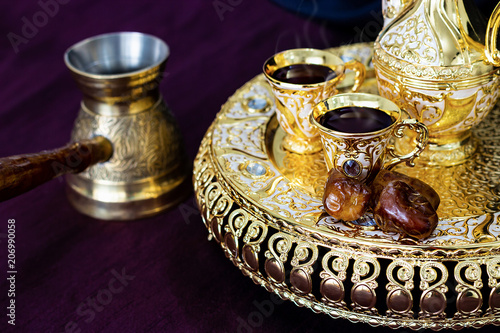 Still life with traditional golden arabic coffee set with dallah photo