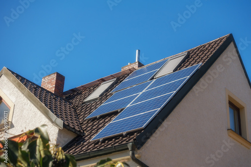 a house with photovoltaic cells on the roof