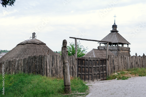 ancient fortification of a wooden palisade, of Cossack state guard army. Panoramic view from Khortytsia island on broad Dnipro summertime, wooden church and houses construction technology photo