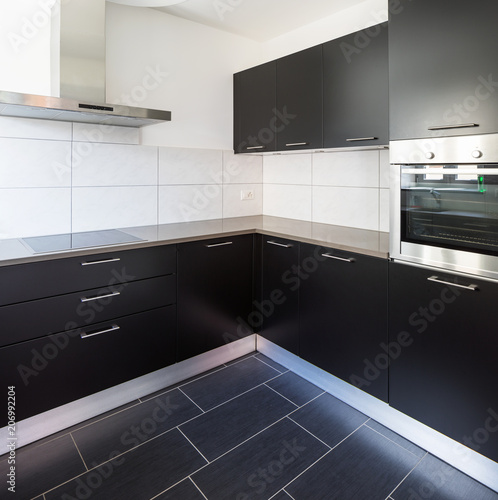 Dark kitchen with many doors and white tiles like parasolizzi