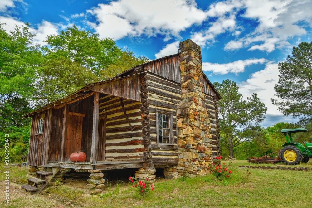An old log cabin in North Carolina on a beautiful day under a blue sky. An old log cabin in North Carolina on a beautiful day under a blue sky.