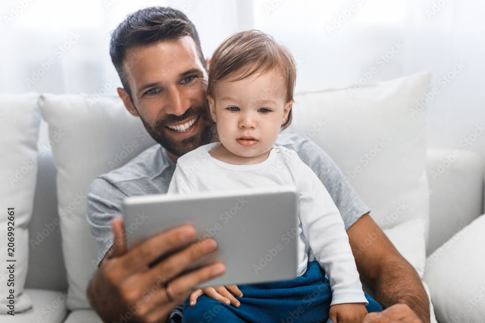 Father and Baby Looking at Tablet Father and Baby Looking at Tablet