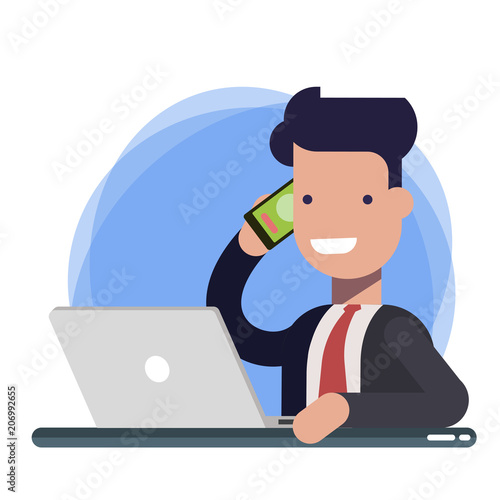 Smiling man talking on mobile phone while using laptop computer at desk in study. Businessman, support or sales manager while communicating with the client.