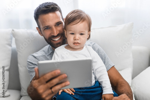 Father and Baby Looking at Tablet