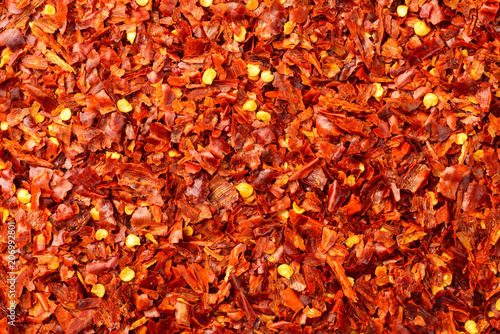 food background of dried red pepper flakes, top view
