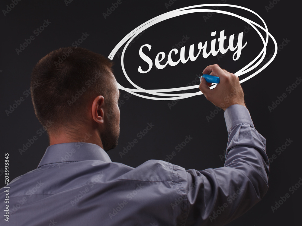 The concept of business, technology, the Internet and the network. Young businessman showing inscription: Security The concept of business, technology, the Internet and the network. Young businessman showing inscription: Security