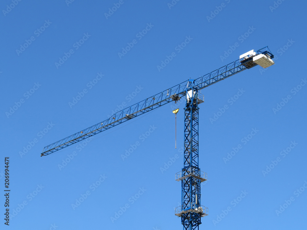 Construction crane isolated on the background of clear blue sky Construction crane isolated on the background of clear blue sky