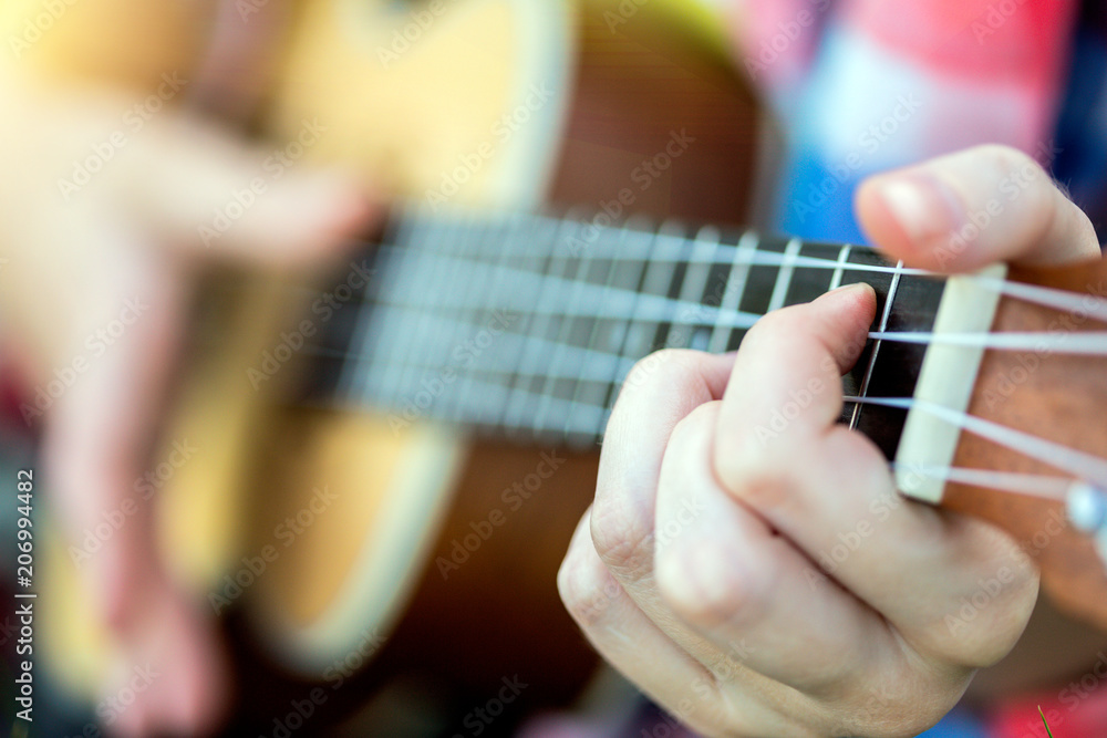 hands playing a guitar close-up