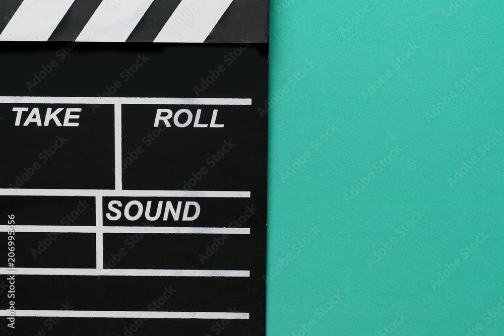 movie clapper on green background ; film, cinema and video photography concept