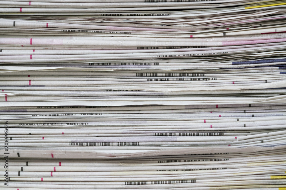 close up newspapers folded and stacked background on the table close up newspapers folded and stacked background on the table