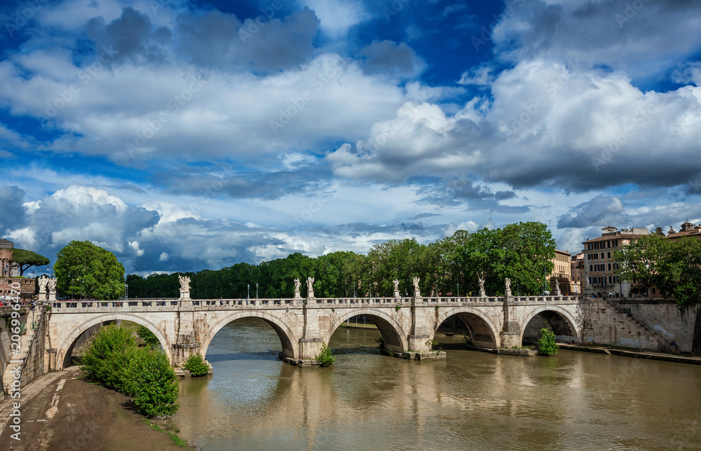 Ponte Sant'Angelo (Holy Angel Bridge) and River Tiber in Rome with spring beautiful clouds